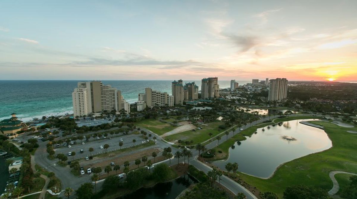 Aerial view of beachfront condo towers, illustrative