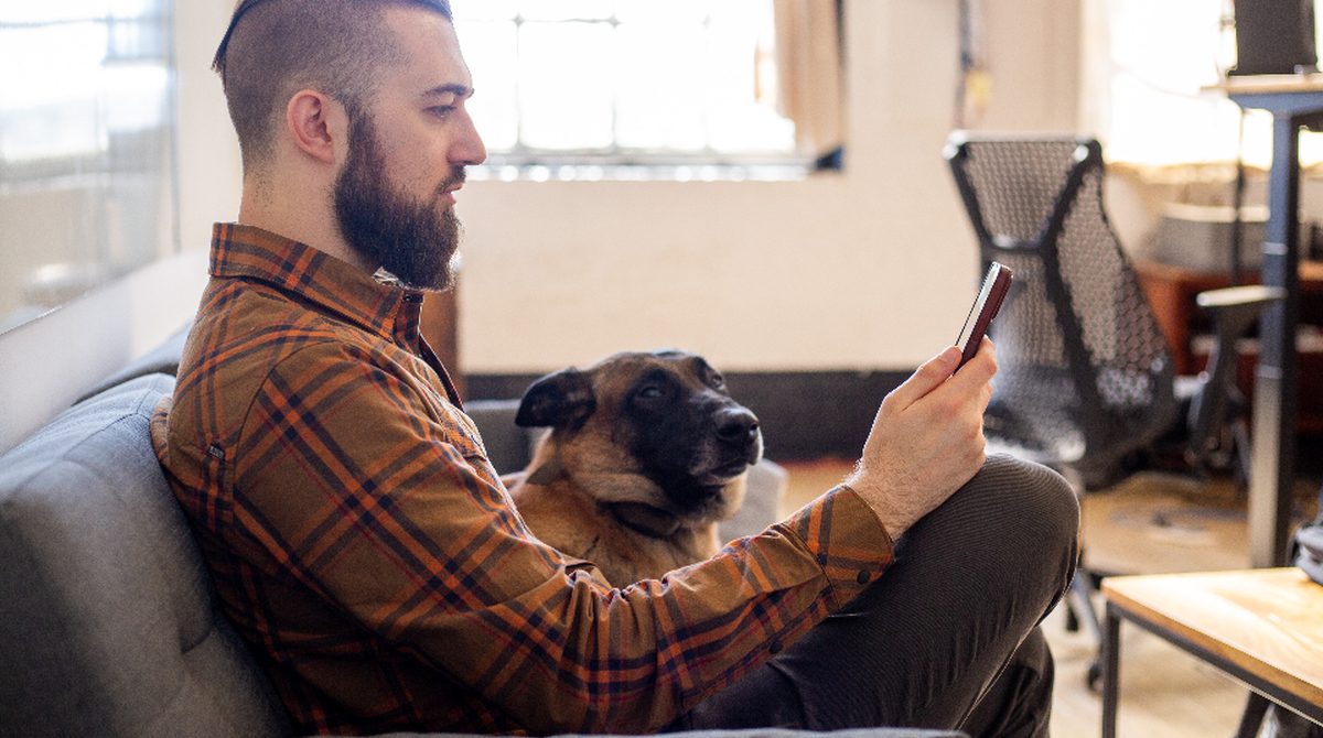 A buyer viewing a new condo building on his phone at home